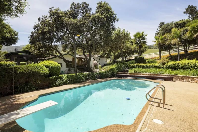 The swimming pool, with oaks and open hills beyond