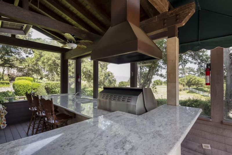 The covered outdoor kitchen and barbecue, looking over the valley